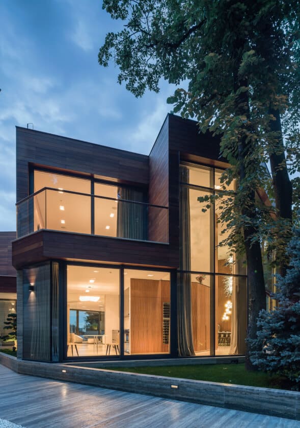 Modern extension with aluminium glazing at dusk