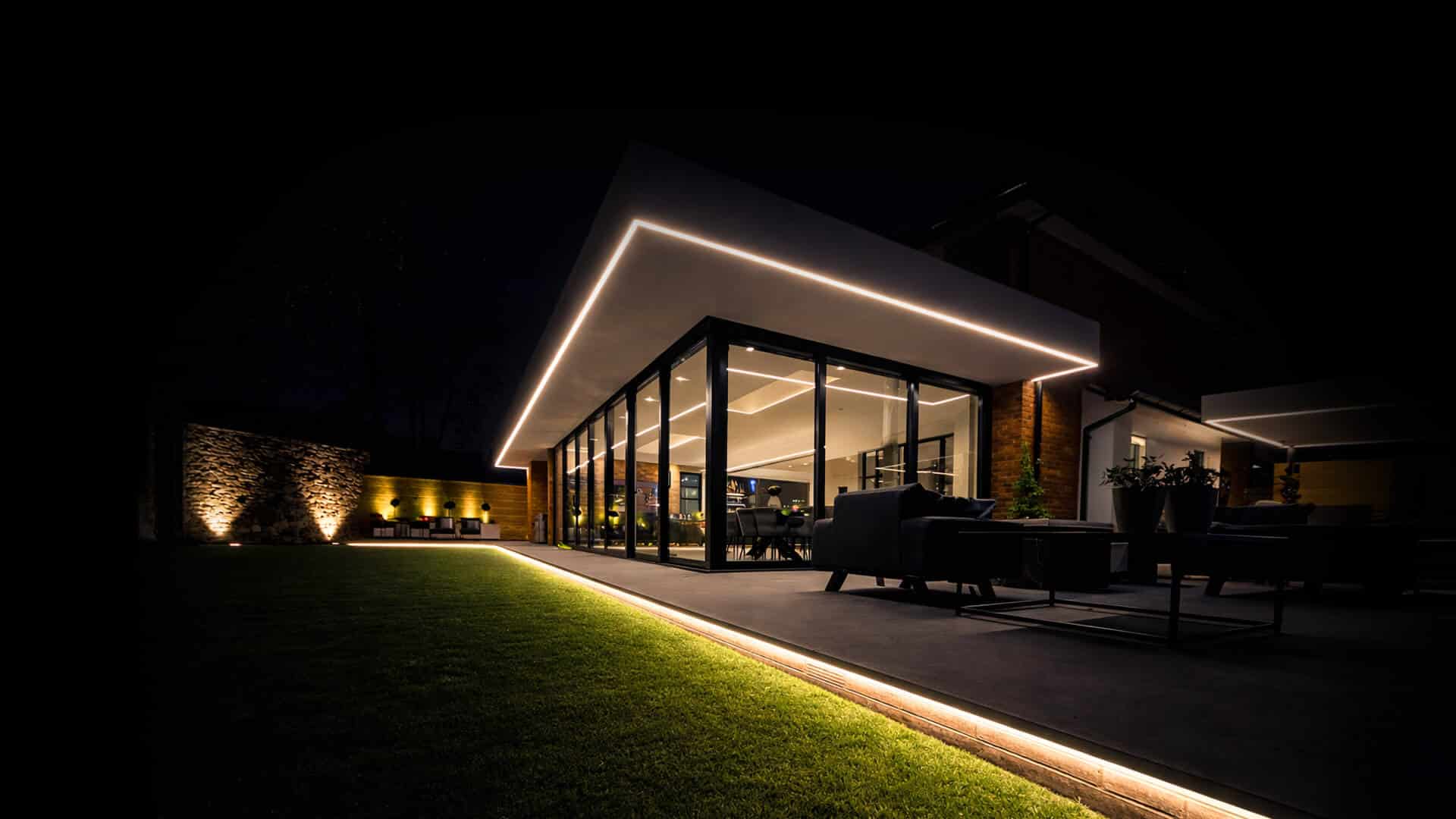 Luxury home with aluminium glazing and pool at night
