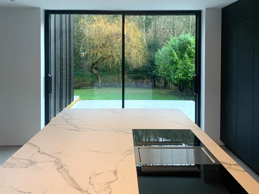 Modern kitchen with roof glazing and aluminium doors